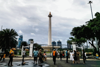 Pengunjung tetap datang berlibur ke kawasan Monas dari luar walaupun peringatan cuaca hujan disertai angin melanda Jakarta, Rabu (28/12/2022).
