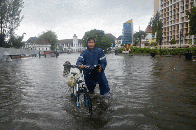 Sejumlah warga harus berjibaku menerjang banjir di kawasan titik nol (KM 0) Semarang, Jawa Tengah, Sabtu (31/12/2022).