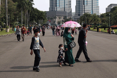 Pengunjung berwisata di kawasan Monumen Nasional (Monas), Jakarta, Rabu (22/3/2023).