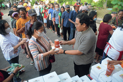 Ratusan warga mengantre untuk mendapatkan paket makanan untuk berbuka puasa yang dibagikan Tim Pelayanan Aksi Piring Kasih di Gereja Santa Theresia.