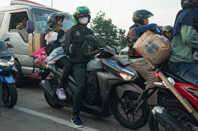 Pemudik menggunakan sepeda motor melintas di Jalan M Hasibuan, Bekasi, Jawa Barat, Selasa (18/4/2023).