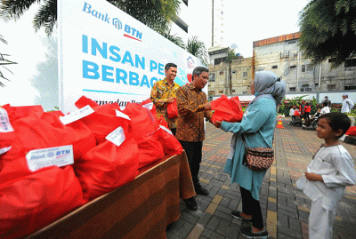 Direktur Utama Bank BTN Nixon LP Napitupulu didampingi Corporate Secretary Bank BTN Ramon Armando membagikan paket sembako.