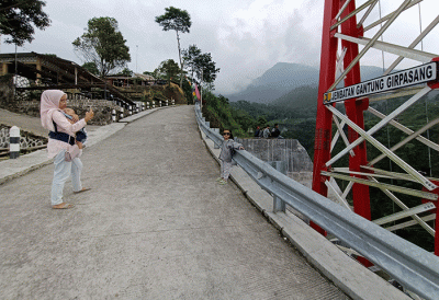 Pengunjung berswa foto di Jembatan Gantung Girpasang di Tegalmulyo, Kemalang, Klaten, Jawa Tengah, Rabu (26/4/2023).