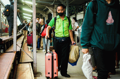 Porter saat membantu pemudik membawa barang di Stasiun Pasar Senen, Jakarta, Rabu (26/4/2023).