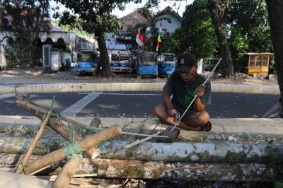 Pedagang membuat tiang panjat pinang dari batang pohon pinang di kawasan Manggarai, Jakarta, Sabtu (12/8/2023).