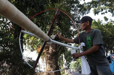Pedagang membuat tiang panjat pinang dari batang pohon pinang di kawasan Manggarai, Jakarta, Sabtu (12/8/2023).