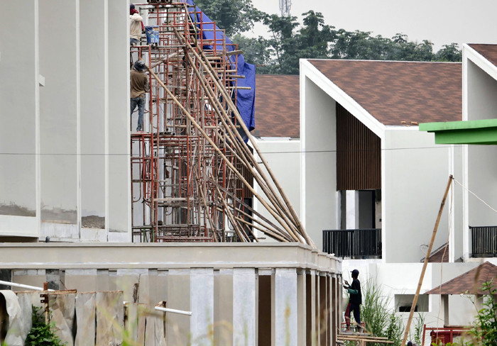 Pekerja menyelesaikan proyek pembangunan rumah di kawasan Cimanggis, Depok, Jawa Barat, Jumat (17/3/2021).