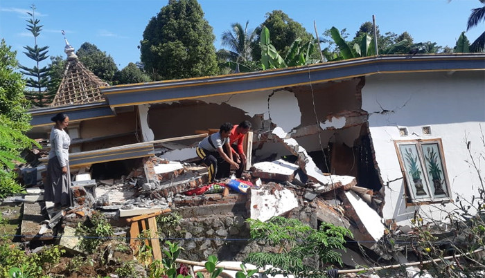 Warga melintas di dekat masjid yang hancur akibat terdampak gempa Malang di Dusun Iburaja, Desa Kaliuling, Kabupaten Lumajang, Jawa Timur, Minggu (11/4/2021).
