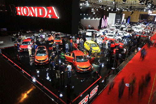 Pengunjung mengamati mobil yang dipamerkan pada ajang Indonesia International Motor Show (IIMS) Hybrid 2021 di JiExpo Kemayoran, Jakarta, Minggu (18/4/2021).
