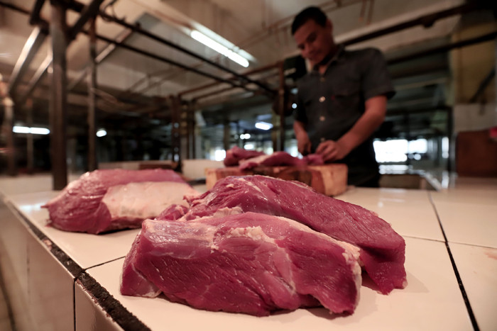 Pedagang memotong daging di Pasar Kramat Jati, Jakarta Timur, Jumat (7/5/2021).
