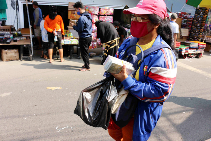 Penjual jasa penukaran uang menawarkan uang baru yang banyak dibutuhkan selama Lebaran di kawasan Pasar Asemka, Jakarta, Rabu (12/5/2021).