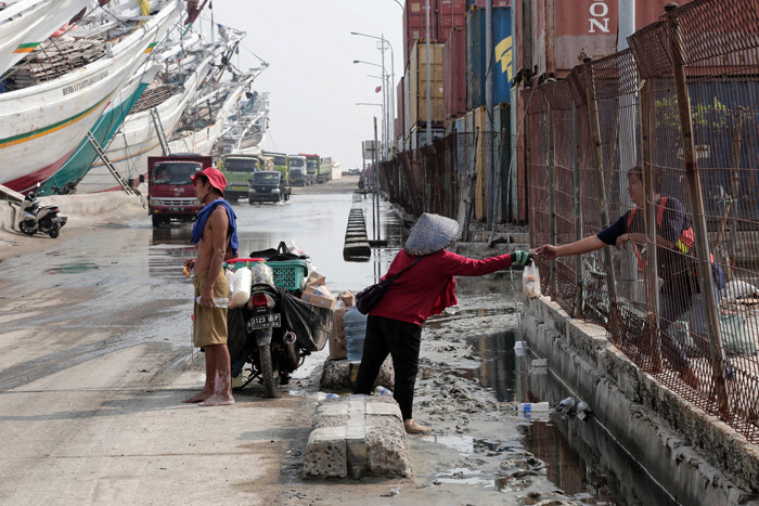 Pengendara melintasi kapal yang bersandar di Pelabuhan Sunda Kelapa, Jakart Utara, Jumat (21/5/2021).