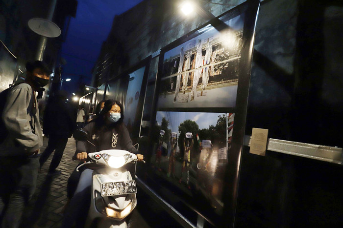 Warga melihat pameran foto Meredah Covid-19 di kawasan Gang Pasar Lama, Jalan Kisamaun, Tangerang, Banten, Sabtu (29/5/2021).