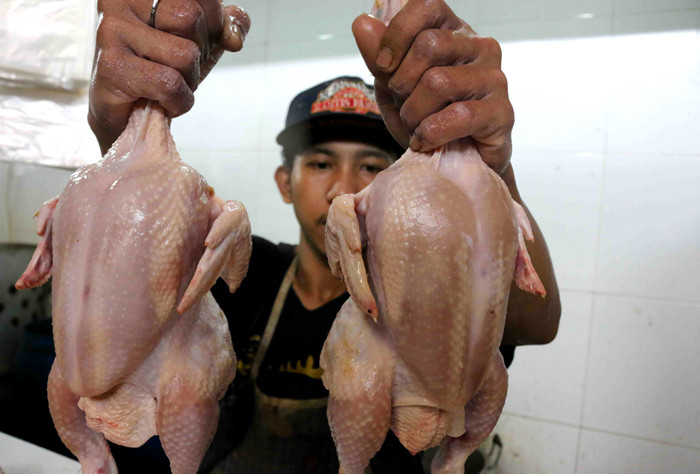 Pedagang memotong daging ayam di Pasar Tradisional Kemayoran, Jakarta Pusat, Sabtu (29/5/2021).