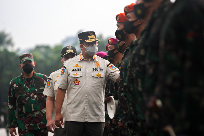Apel persiapan pasukan gabungan TNI, Polri dan Satpol PP di Tugu Monas, Jakarta Pusat, Jumat (18/6/2021).