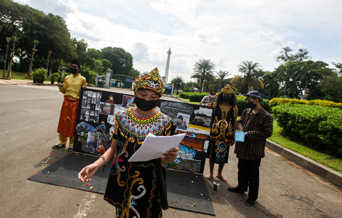 Demonstran melakukan aksi teatrikal menolak revisi UU Minerba di kawasan Bundaran Patung Kuda Arjuna Wijaya, Jakarta, Senin (21/6/2021).
