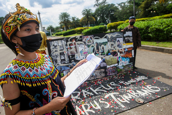 Demonstran melakukan aksi teatrikal menolak revisi UU Minerba di kawasan Bundaran Patung Kuda Arjuna Wijaya, Jakarta, Senin (21/6/2021).
