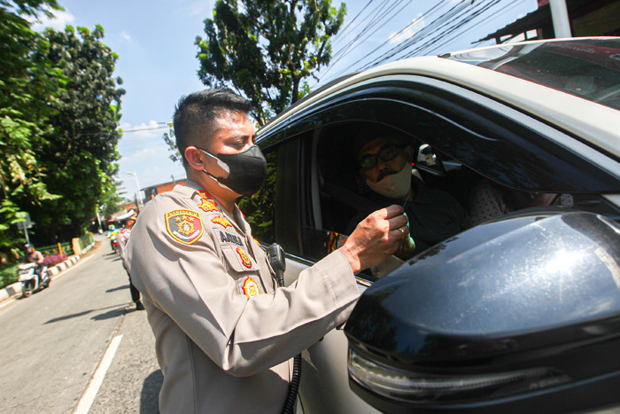 Petugas TNI-Polri menggunakan mobil lapis baja Barracuda saat pelaksanaan PPKM Darurat di Jalan Raya Lenteng Agung, Minggu (4/7/2021).