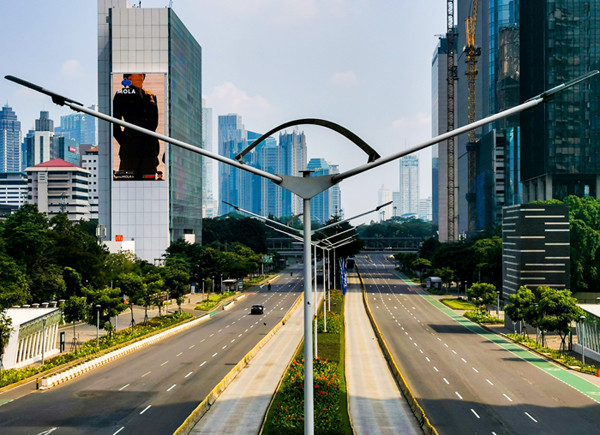 Suasana Jalan Sudirman terlihat lengang pada hari kedua PPKM darurat di Jakarta Pusat, Minggu (4/7/2021).
