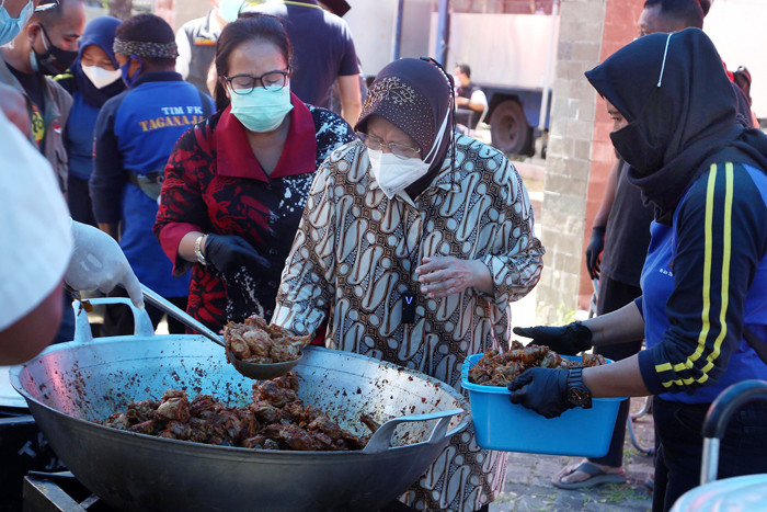 Mensos Tri Rismaharini ikut memasak untuk para pejuang Covid-19 di Dapur Umum di area halaman Convention Hall Surabaya, Jawa Timur, Senin (5/7/2021).