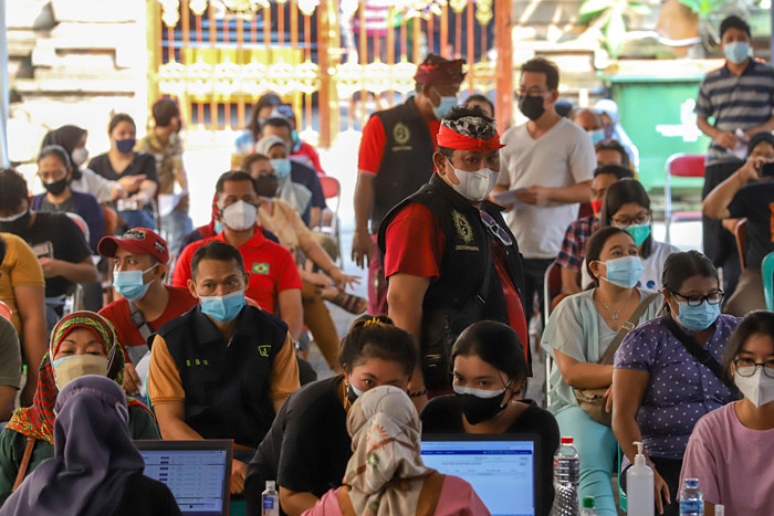 Warga saat mengikuti vaksinasi massal Covid-19 di rumah ibadah Pure Candra Prabha, Jakarta Barat, Senin (5/7/2021).