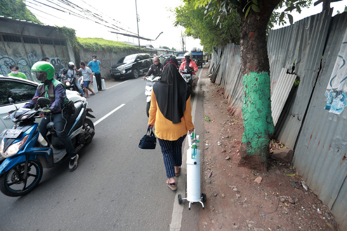 Warga mengantre untuk mengisi ulang tabung oksigen di kawasan Pesanggrahan, Jakarta, Kamis (8/7/2021).