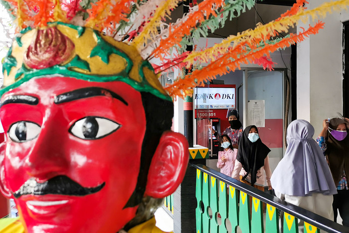 Orang tua saat mengambil dana Kartu Jakarta Pintar (KJP) Plus untuk tingkat Sekolah Dasar (SD) di ATM Bank DKI, Jakarta Barat, Kamis (15/7/2021).