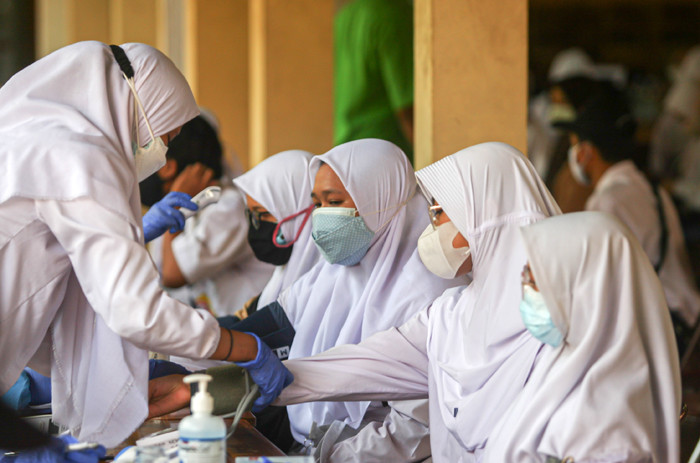Siswa Sekolah Menengah Atas saat menerima Vaksin varian Sinovac di SMAN 113, Jakarta Timur, Rabu (21/7/2021).