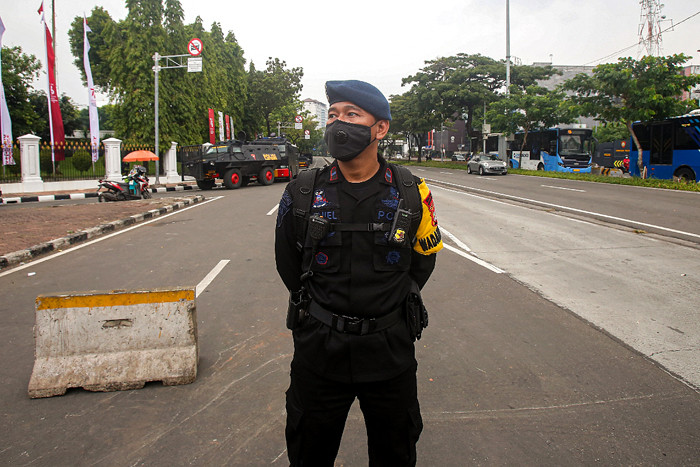 Pengendara melintasi kawat berduri yang terpasang di kawasan Harmoni, Jakarta Pusat, Sabtu (24/7/2021).