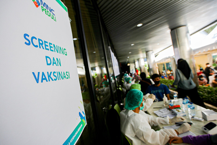 Antrean warga menunggu giliran pendaftaran untuk melakukan Vaksin Covid-19 di Sentra Vaksinasi MNC Peduli, MNC Center, Kebon Sirih, Selasa (27/7/2021).