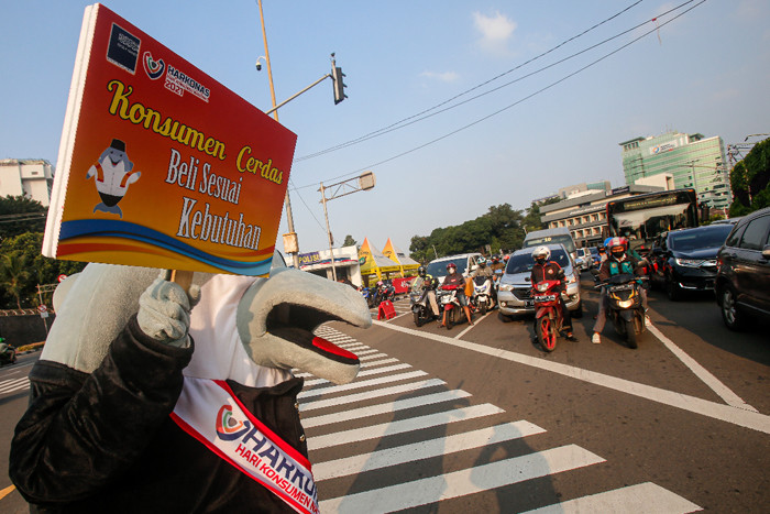 Maskot Hari Konsumen Nasional (HARKONAS) Si Enda melakukan aksi kampanye kepada pengendara yang melintas di kawasan Tugu Tani, Jakarta Pusat, Selasa (3/8/2021).