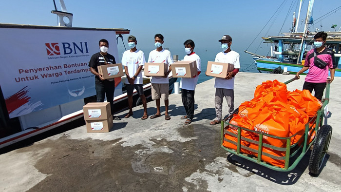 Warga pesisir Pulau Panjang mendapatkan paket bantuan sembako dari BNI di Serang, Banten, Kamis (12/8/2021).