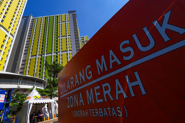 Warga dan nakes saat melintas di kawasan tower RSDC-19 Rumah Susun (Rusun) Pasar Rumput, Jakarta Selatan, Kamis (12/8/2021).