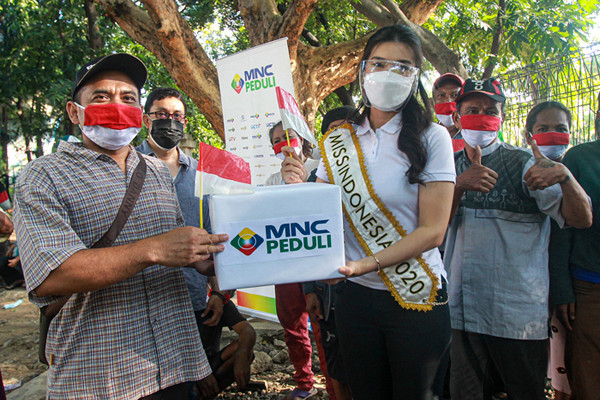 Miss Indonesia 2020 Pricilia Carla Yules memberikan bantuan kepada warga yang tinggal di bawah kolong Stasiun Juanda, Jakarta Pusat, Senin (16/8/2021).