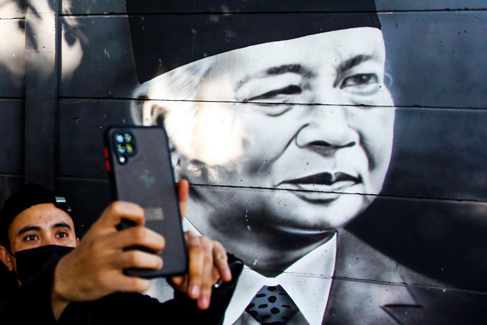 Warga saat melintasi mural para presiden dan pahlwan republik Indonesia di kawasan Cipondoh, Kota Tangerang, Senin (16/8/2021).