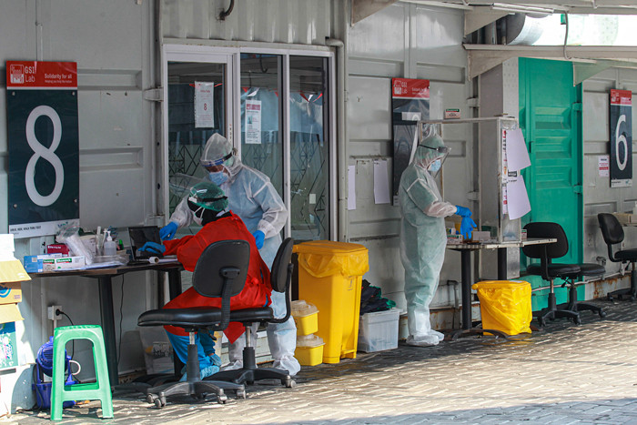 Petugas melakukan swab PCR kepada warga secara drive thru di GSI Lab, Jakarta Selatan, Selasa (17/8/2021).