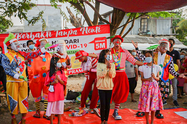 Sejumlah Badut yang tergabung dalam komunitas ABI menghibur anak-anak korban kebakaran di pengungsian kawasan Kemang Utara IX, Jakarta, Rabu (18/8/2021).