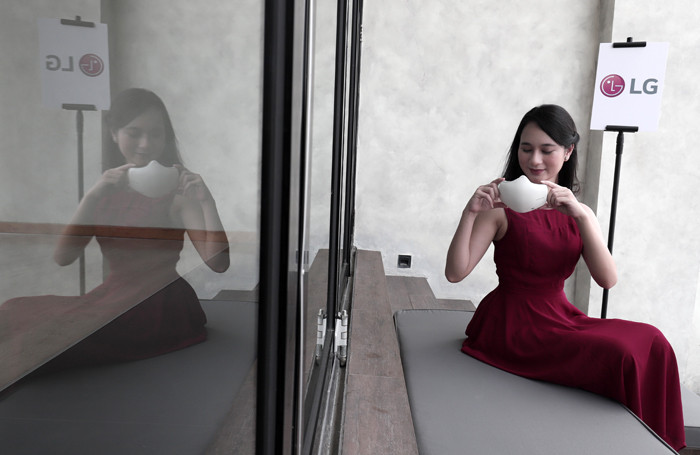 Model menunjukkan LG PuriCare Wearable Air Purifier di Jakarta, Kamis (19/8/2021).