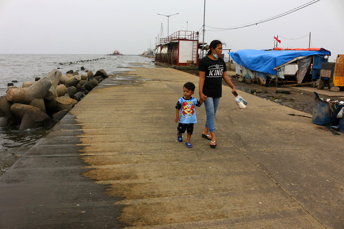 Warga dan anak-anak bermain di kawasan Pelabuhan Kaliadem, Muara Angke, Jakarta, Sabtu (21/8/2021).