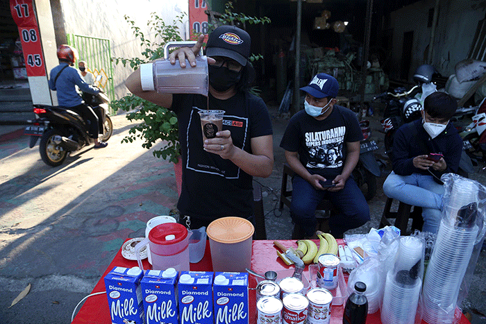 Rock Star Surabaya, Muhammad Maulana Amrullah meracik kopi kekinian di lapak sederhananya di pinggir Jalan Demak Surabaya, Jawa Timur, Kamis (26/8/2021).