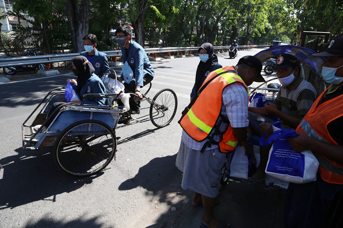 Mahasiswa Baru Universitas Dr Soetomo Surabaya membagikan sembako pada warga kurang mampu di sekitar kampus Unitomo Surabaya, Jawa Timur, Jumat (3/9/2021).