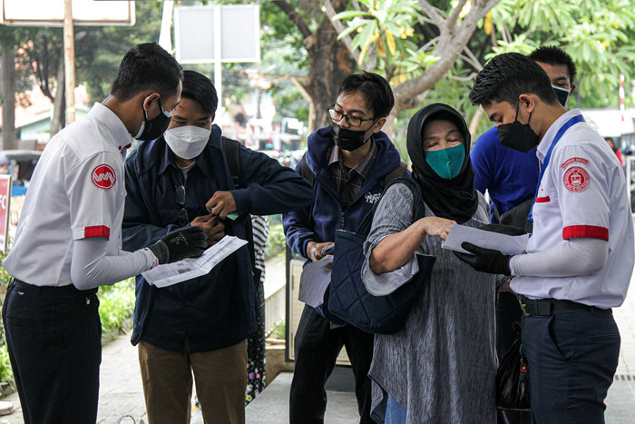 Calon penumpang memindai kode batang dari aplikasi PeduliLindungi sebelum melakukan perjalanan di Stasiun Manggarai, Jakarta, Selasa (7/9/2021).