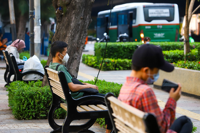 Pekerja saat duduk-duduk ditaman sambil menunggu transportasi di Kawasan, Slipi, Jakarta Barat, Kamis (9/9/2021).
