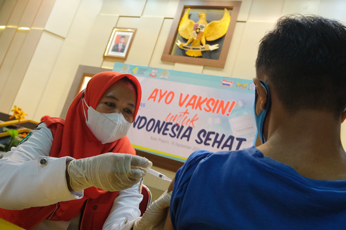 Suasana antusiasme warga mengantri untuk melakukan vaksin di Gedung Manunggal, Kota Makassar, Minggu (19/9/2021).