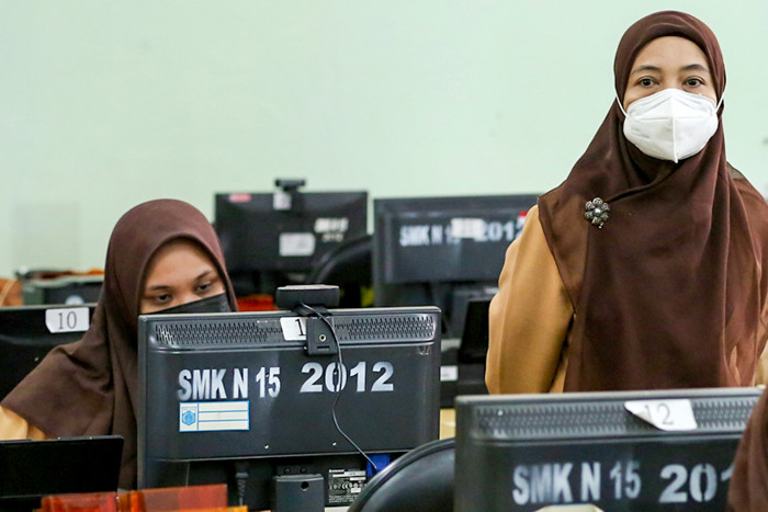 Guru pengajar saat mengawasi pelaksanaan Asesmen Nasional Berbasis Komputer (ANBK) 2021 di SMK 15, Jakarta, Rabu (22/9/2021).
