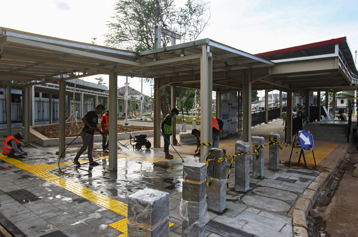 Para pekerja sedang menyelesaikan revitalisasi halaman Stasiun Manggarai, Jakarta Selatan, Minggu (26/9/2021).