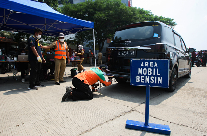 Petugas melakukan uji emisi gas buang kendaraan bermotor di Jalan Perintis Kemerdekaan, Pulogadung, Jakarta Timur, Selasa (26/10/2021).