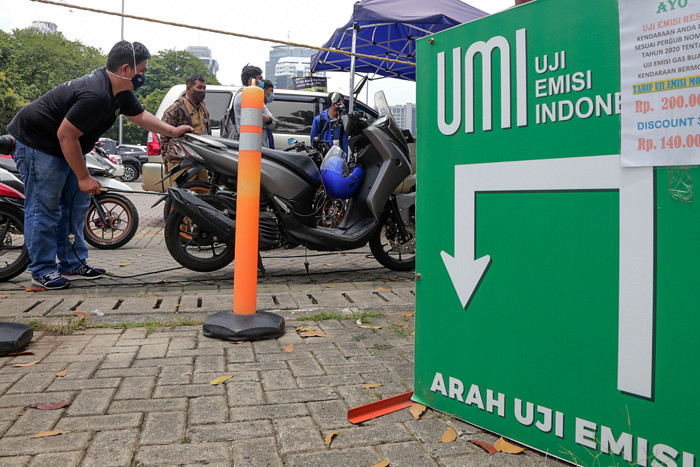Petugas melakukan uji emisi gas buang kendaraan milik warga di Lapangan Parkir IRTI Monas, Jakarta Pusat, Senin (1/11/2021).