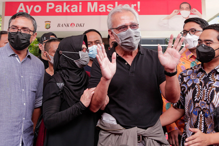 Musisi Iwan Fals melambaikan tangan dari dalam mobil usai menyambangi Mapolda Metro Jaya, Jakarta Selatan, Kamis (4/11/2021).