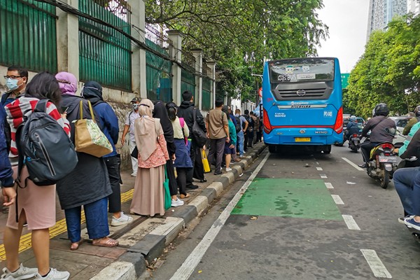 Penumpang saat mengantri masuk Transjakarta di kawasan Jakarta Pusat, Selasa (9/11/2021).